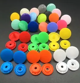 Coloured plastic snap fasteners in a range of sizes and colours