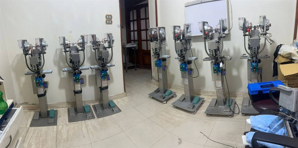 Row of snap-attaching press machines on the Pioneer pressing floor
